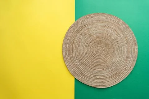 Table setting with table mat and dinnerware with green and yellow background. Stock Photos