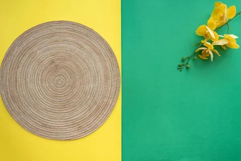 Table setting with table mat and dinnerware with green and yellow background. Stock Photos