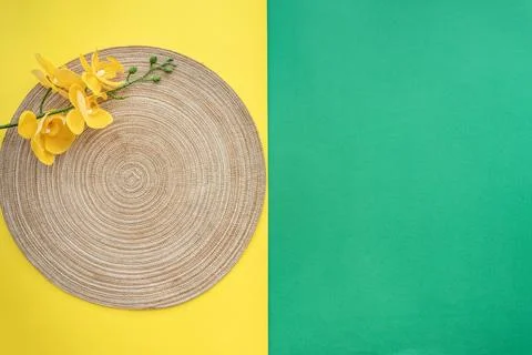 Table setting with table mat and dinnerware with green and yellow background. Stock Photos