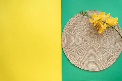 Table setting with table mat and dinnerware with green and yellow background. Stock Photos