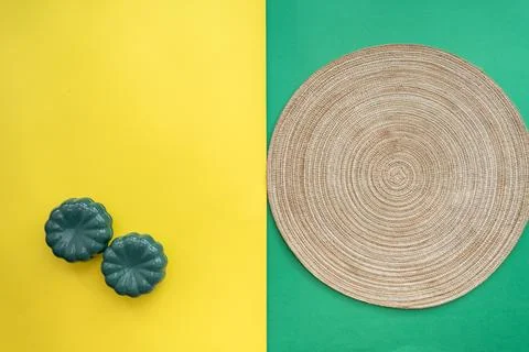 Table setting with table mat and dinnerware with green and yellow background. Stock-Fotos