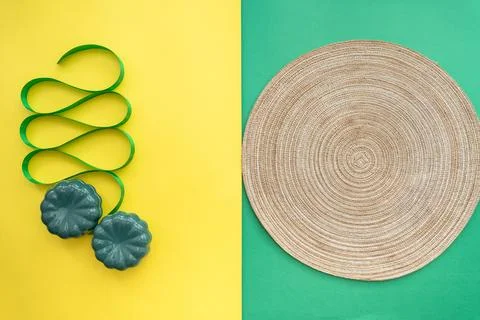 Table setting with table mat and dinnerware with green and yellow background. Stock Photos