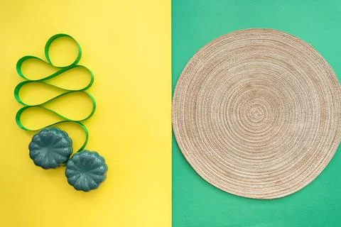 Table setting with table mat and dinnerware with green and yellow background. Stock Photos