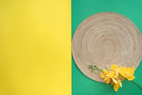 Table setting with table mat and dinnerware with green and yellow background. Stock Photos