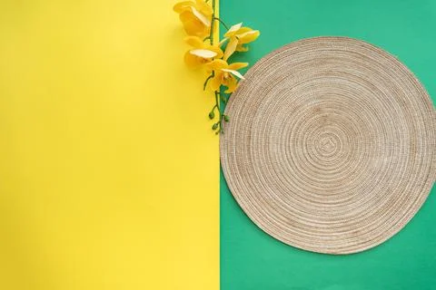 Table setting with table mat and dinnerware with green and yellow background. Stock Photos