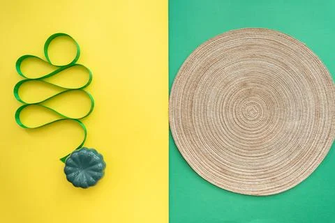 Table setting with table mat and dinnerware with green and yellow background. Stock Photos