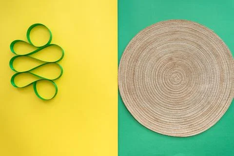 Table setting with table mat and dinnerware with green and yellow background. Stock Photos