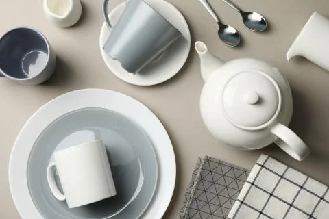 Table setting with teapot on grey background, top view Fotos de archivo