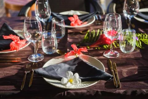 Table setting with tropic flowers and tableware Stock Photos