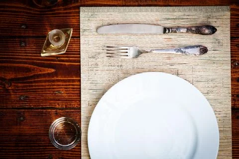Table setting for two with empty plates - rustic wooden table Stock Photos