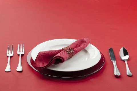 Table setting with utensils plate and red cloth Stock Photos