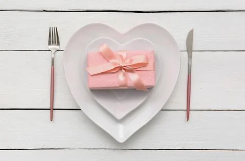 Table setting for Valentine's Day with gift box on white wooden background Stock Photos