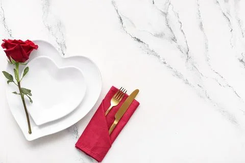 Table setting for Valentine's Day with red rose flower on marble background Stock Photos