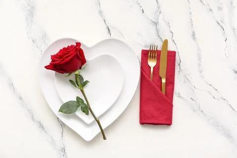Table setting for Valentine's Day with red rose flower on marble background Stock Photos