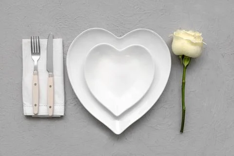 Table setting for Valentine's Day with rose flower on grey grunge background Stock Photos