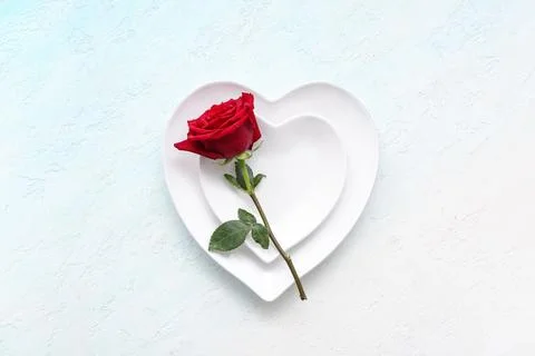 Table setting for Valentine's Day with rose flower on blue grunge background Stock Photos