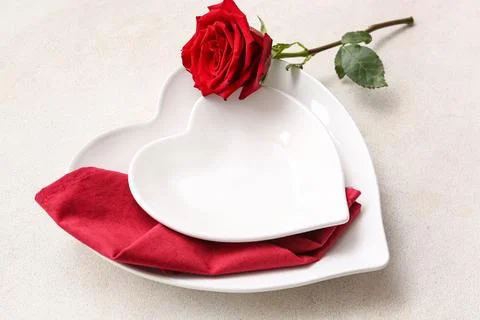 Table setting for Valentine's Day with rose flower on white grunge background Stock Photos
