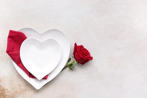 Table setting for Valentine's Day with rose flower on white grunge background Stock Photos