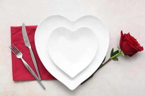 Table setting for Valentine's Day with rose flower on white grunge background Stock Photos