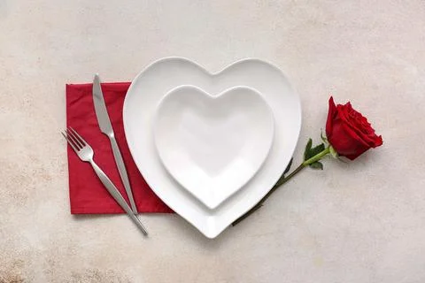 Table setting for Valentine's Day with rose flower on white grunge background Stock Photos