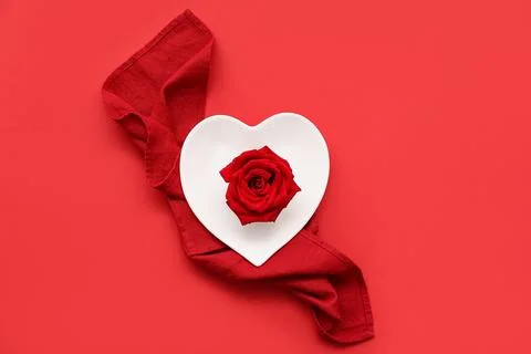Table setting for Valentine's Day with rose flower on red background Stock Photos