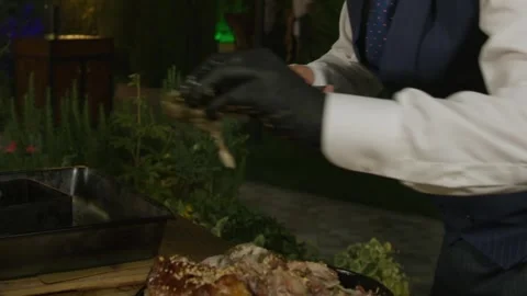 Table setting by a waiter in a night open cafe surrounded by trees and fir trees Stock Footage 256128856