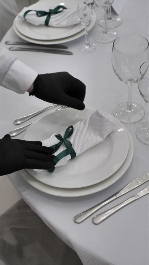 Table setting. A waiter serves a table in a restaurant. Festive table setting Stock Footage 306750842