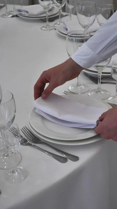 Table setting. A waiter serves a table in a restaurant. Festive table setting Stock Footage 313963137