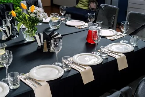 Table setting for a wedding or dinner event, black tablecloth white plates-2. Stock Photos