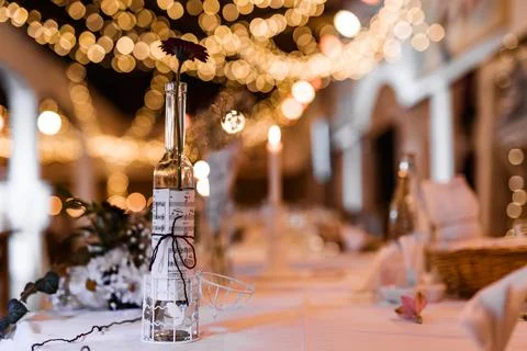 Table setting for wedding party decor flowers lights blurred background Stock Photos