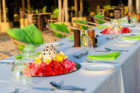 Table setting for wedding reception with red and yellow flowers Stock Photos