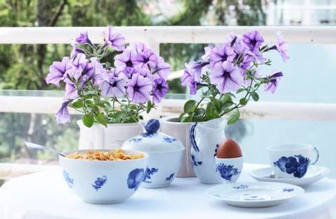 Table setting with white and blue Coffee set and Summer Flowers Stock Photos