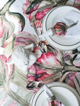 Table setting. White ceramic angel, napkins with red flowers Stock Photos