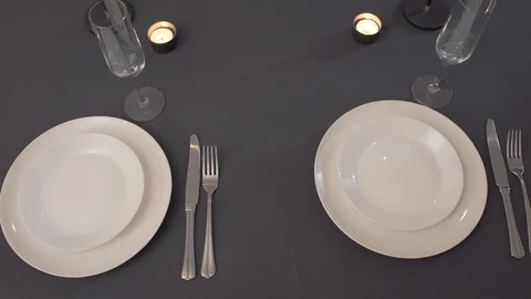 Table setting with white dishes. dinner cutlery Stock Footage 128382450