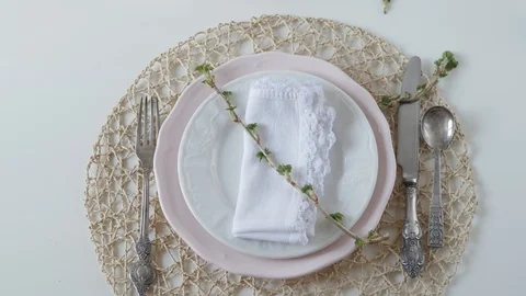 Table setting with white dishes on white background. the woman beautifully folds Stock-Footage 108328294