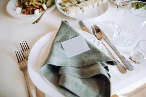 Table setting with white plate, olive napkin. Trendy rustic table setting Stock Photos