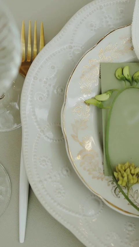 Table setting with white plates and beautiful floral accents. Served tables for Stock Footage 306529908