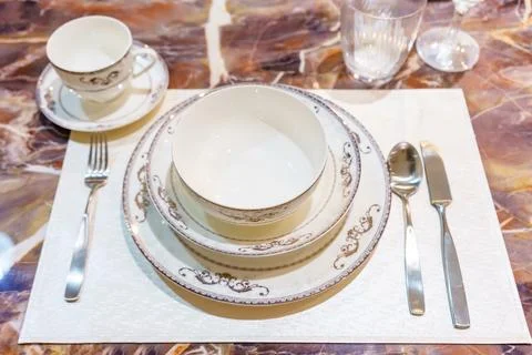 Table setting on wooden dinning table at home Stock Photos