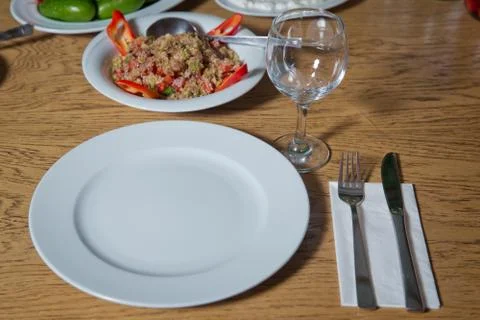 Table setting on wooden table . Dinner place setting. A white plate with silv Stock Photos