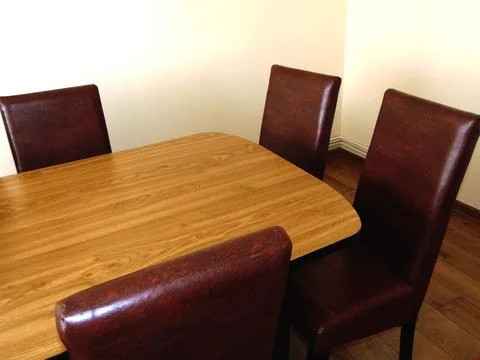 Table with several chairs in a house Stock Photos