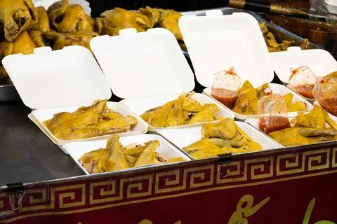A table with several containers of food, including chicken Stock Photos