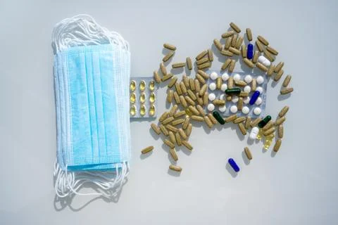 A table with several surgical masks. Assorted pharmaceutical medicine pills Stock Photos