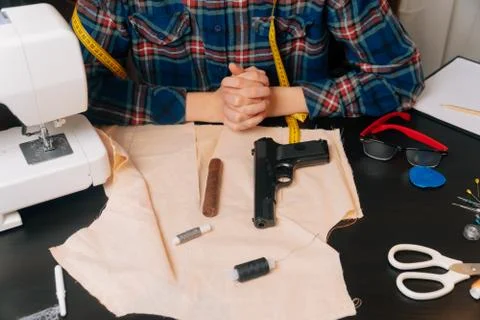 On the table in the sewing workshop are Cuban cigars and an air pistol. Choos Stock Photos