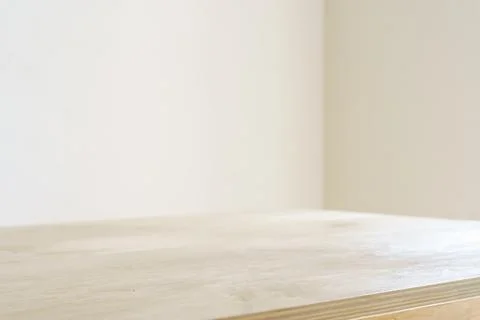 Table shadow background. Wooden table and white empty wall with plant shadows. Stock Photos