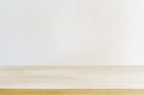Table shadow background. Wooden table and white empty wall with plant shadows. Stock Photos