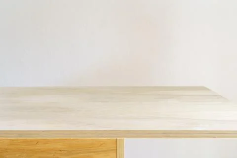 Table shadow background. Wooden table and white empty wall with plant shadows. Stock Photos