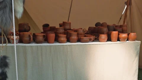 A table shows various pottery items in multiple shapes and sizes. This display Stock Footage 345029957