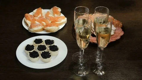On the table is a snack and champagne. Caviar Stock Footage 73067951
