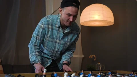 Table Soccer Game  Caucasian Man is Having Fun Playing Kicker Stock Footage 150291394