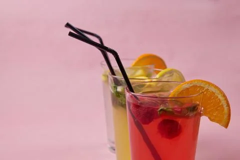 On the table, soft drinks, various cocktails, a glass with a straw and a slice Stock Photos